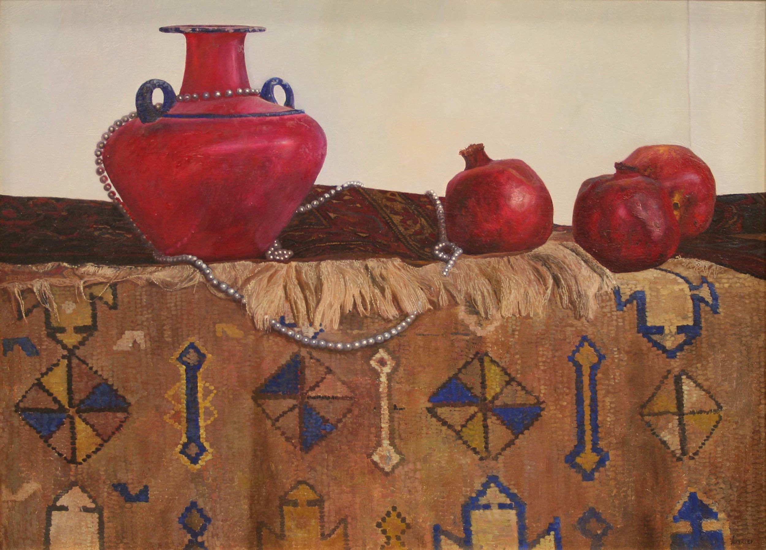 Two rugs with a red pot and pomegranates on it.