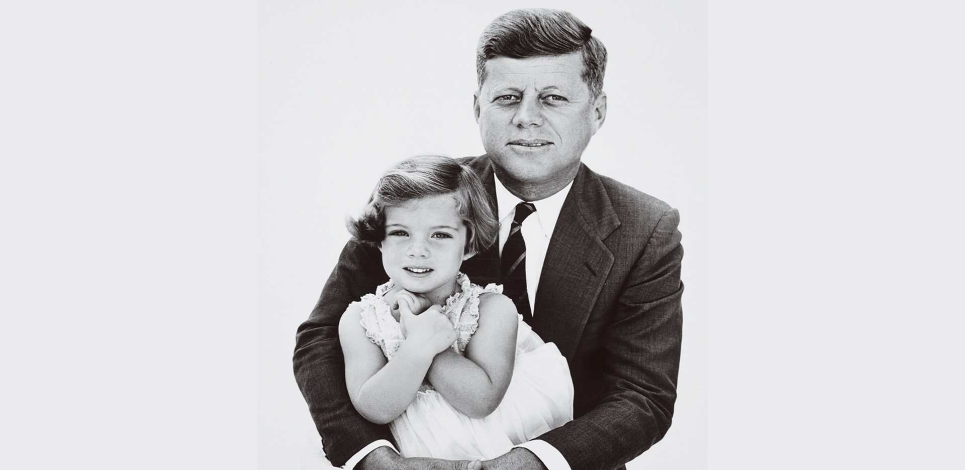 John F. Kennedy holding his daughter.