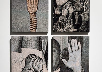Four tapestries depicting hands of Black people.
